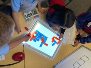 Students playing with tiles.